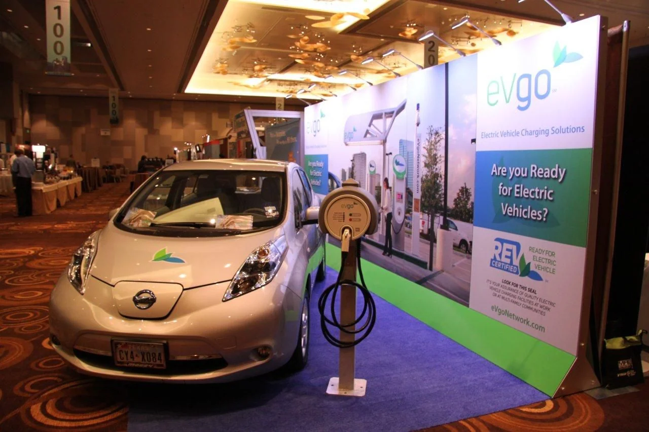 Electric car and charging station at an EVgo trade-show exhibit