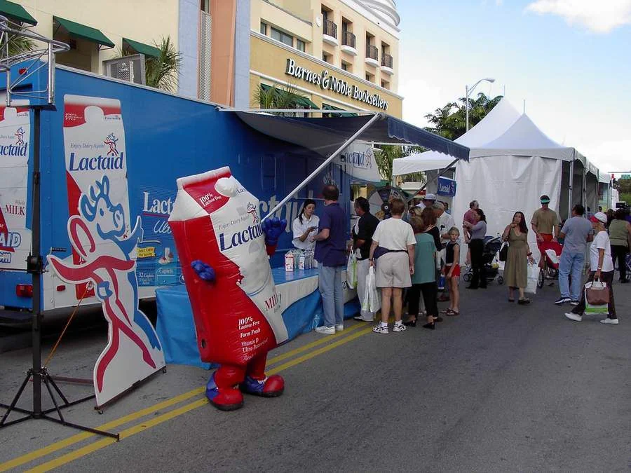Lactaid sampling trailer and mascot at an outdoor event