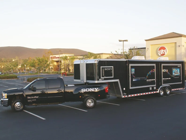Sony-branded pickup and mobile trailer in a parking lot outside Circuit City
