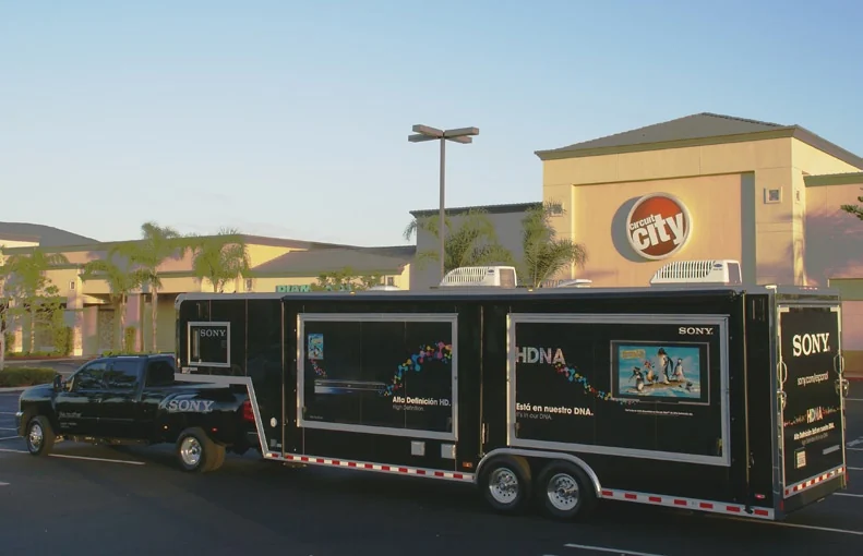Wide side view of the Sony roadshow truck and trailer outside Circuit City