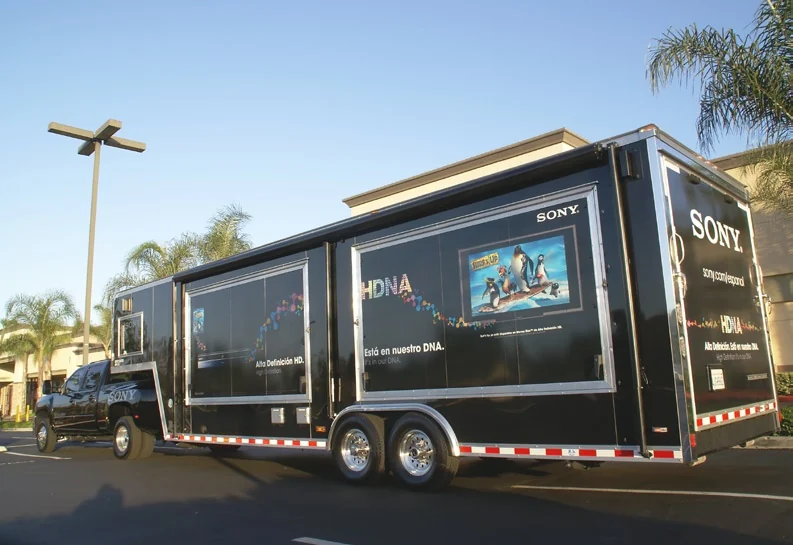 Rear three-quarter view of the Sony mobile trailer with palm trees behind it