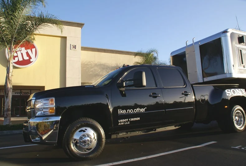 Close view of the black Sony-branded pickup beside a Circuit City building